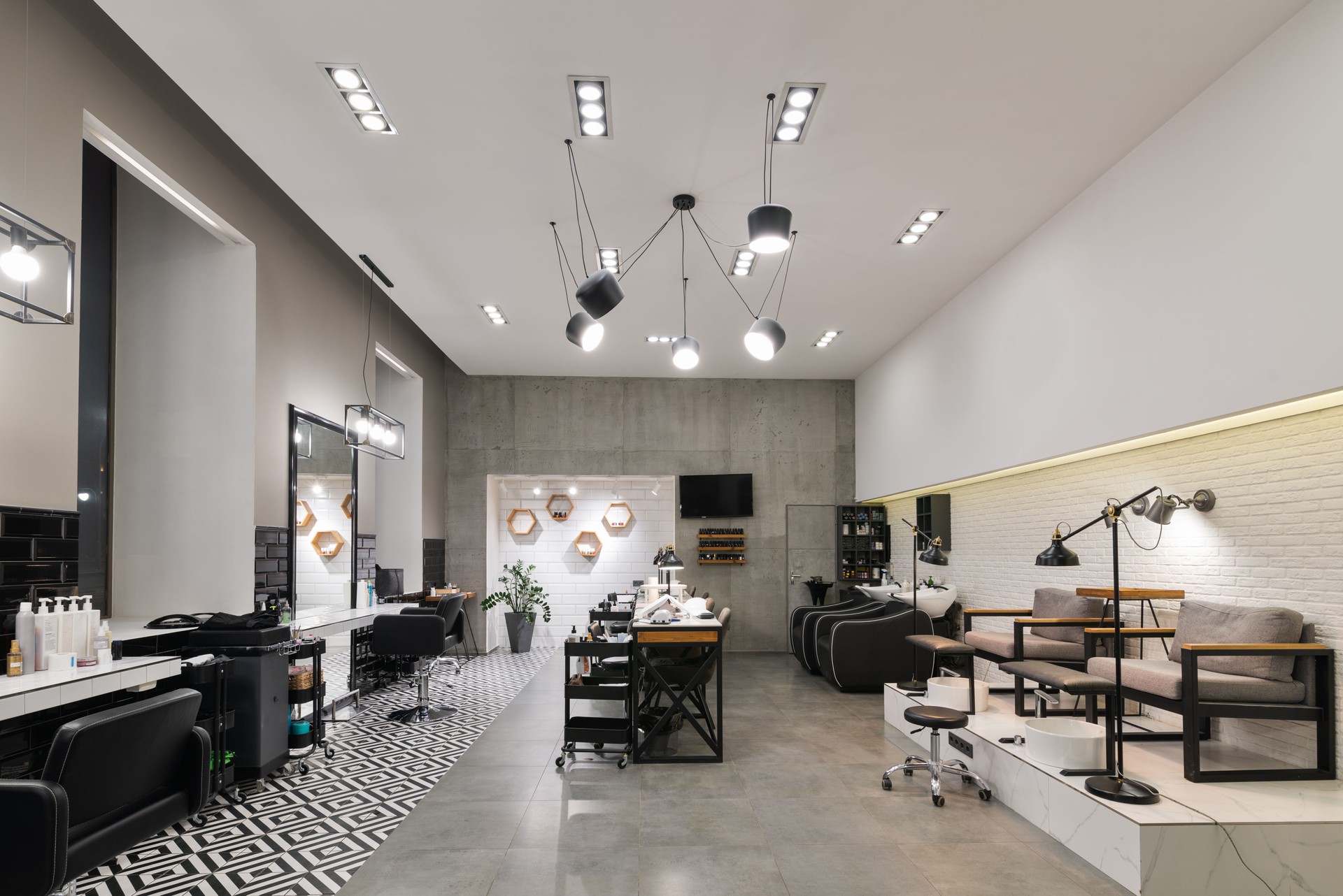 Modern interior of the beauty salon which consist of nail salon and barbershop.